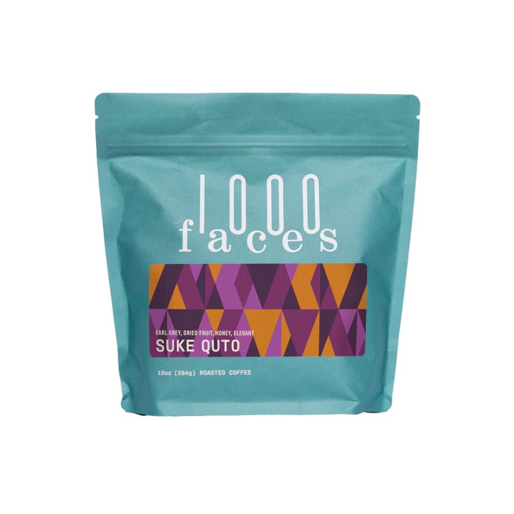 Teal coffee bag with '1000 faces' branding and colorful label on a white background – 1000Faces Coffee main product