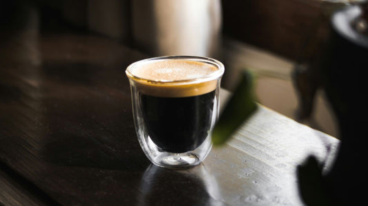 Cup of coffee sitting on a wooden plate