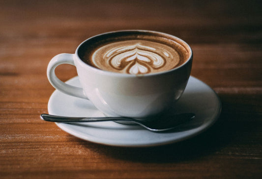 White ceramic teacup with coffee latte art