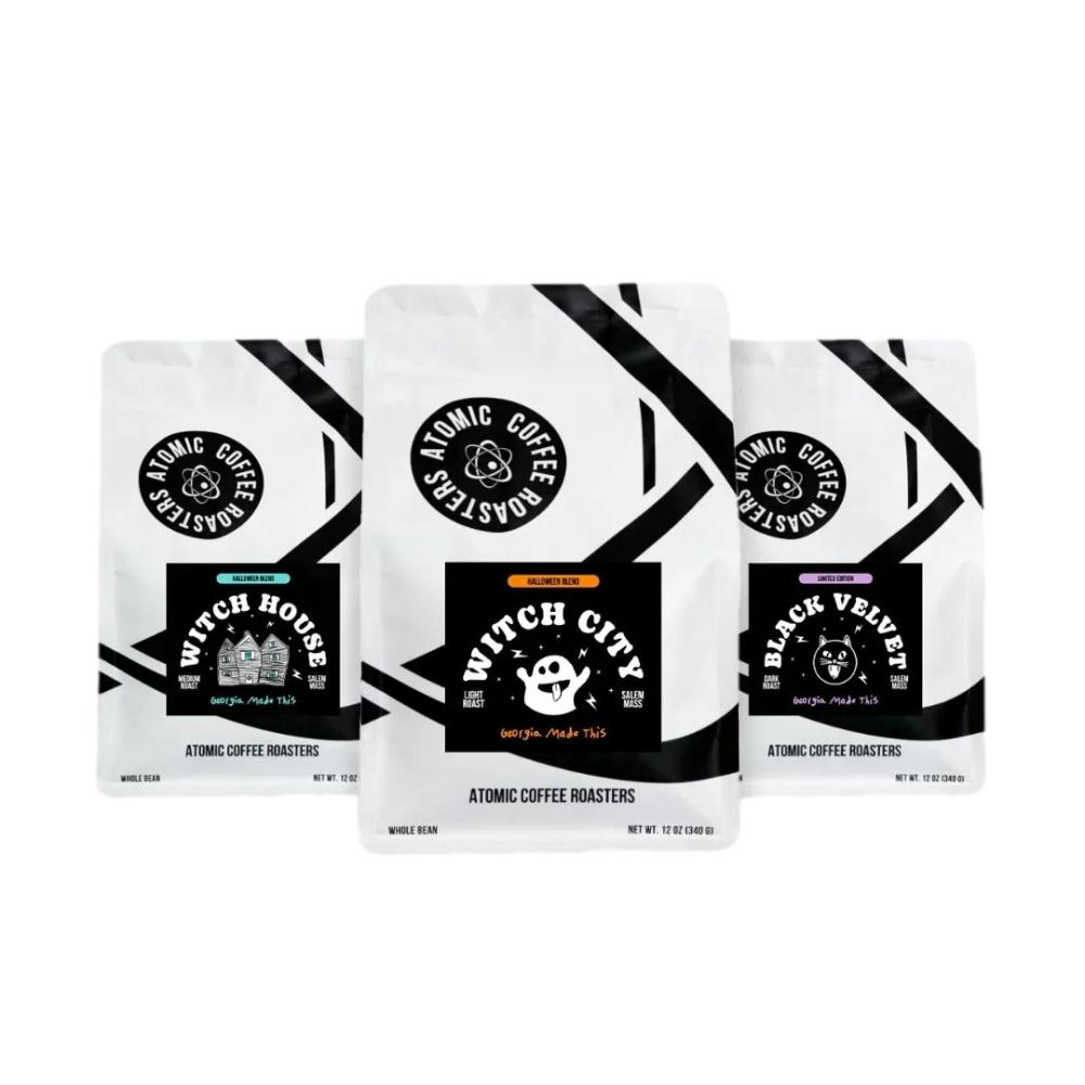Three bags of Atomic Coffee Roasters single-serve coffee on a plain white background. The center bag is labeled 'Witch City' and is slightly forward, flanked by 'Witch House' on the left and 'Black Velvet' on the right. – Atomic Coffee Roasters main product
