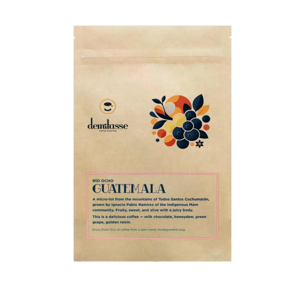A stand-up kraft paper bag of Demlasse Bio Ocho Guatemala coffee, featuring a colorful graphic of coffee cherries and descriptive text on a white background. – Demitasse main product