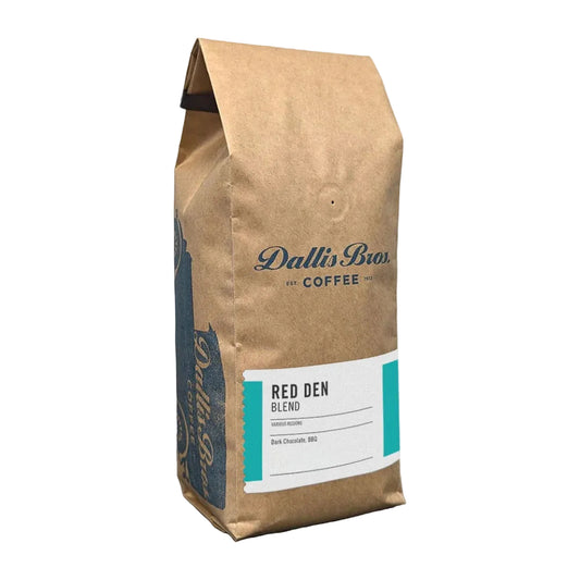 A 12 oz bag of Dallin Bior Red Den Coffee Blend in a brown kraft paper bag with a white and teal label, shown on a plain white background.