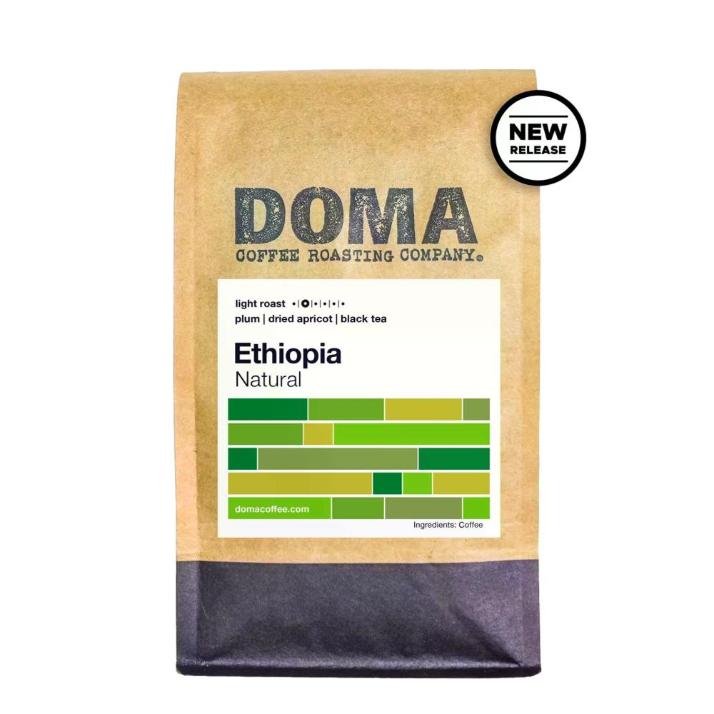 A bag of Doma Coffee Roasting Company Ethiopia Natural light roast coffee on a white background, featuring a kraft paper bag with a white label and a black circular 'NEW RELEASE' badge.