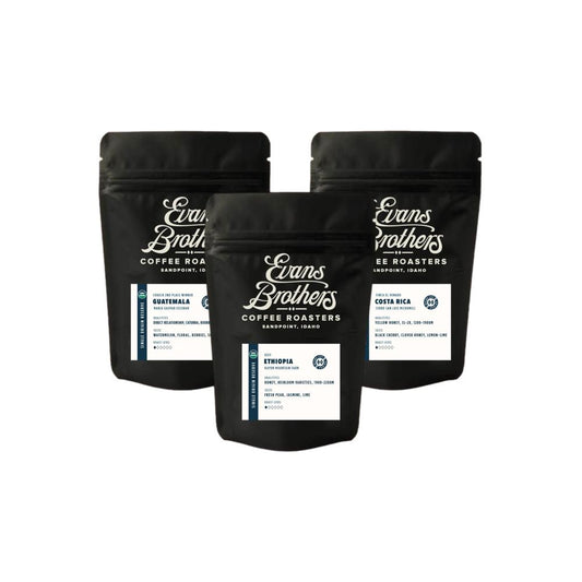 Three black coffee bags from Evans Brothers Coffee Roasters on a white background