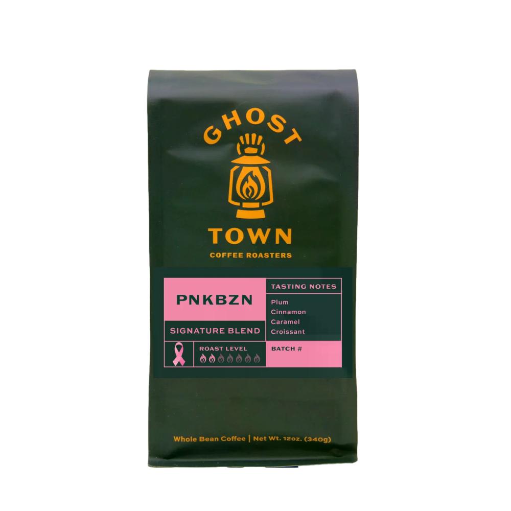A 12 oz bag of Ghost Town Coffee Roasters PNKBZN Signature Blend whole bean coffee. The bag is dark forest green with yellow branding and a pink and dark green label on the front. – Ghost Town Coffee Roasters main product