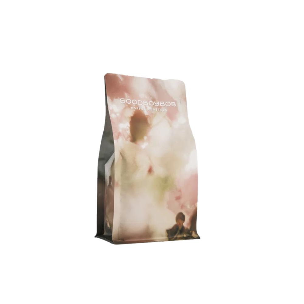 Goodboyies dog treats packaging with a dog and cherry blossoms design on a white background