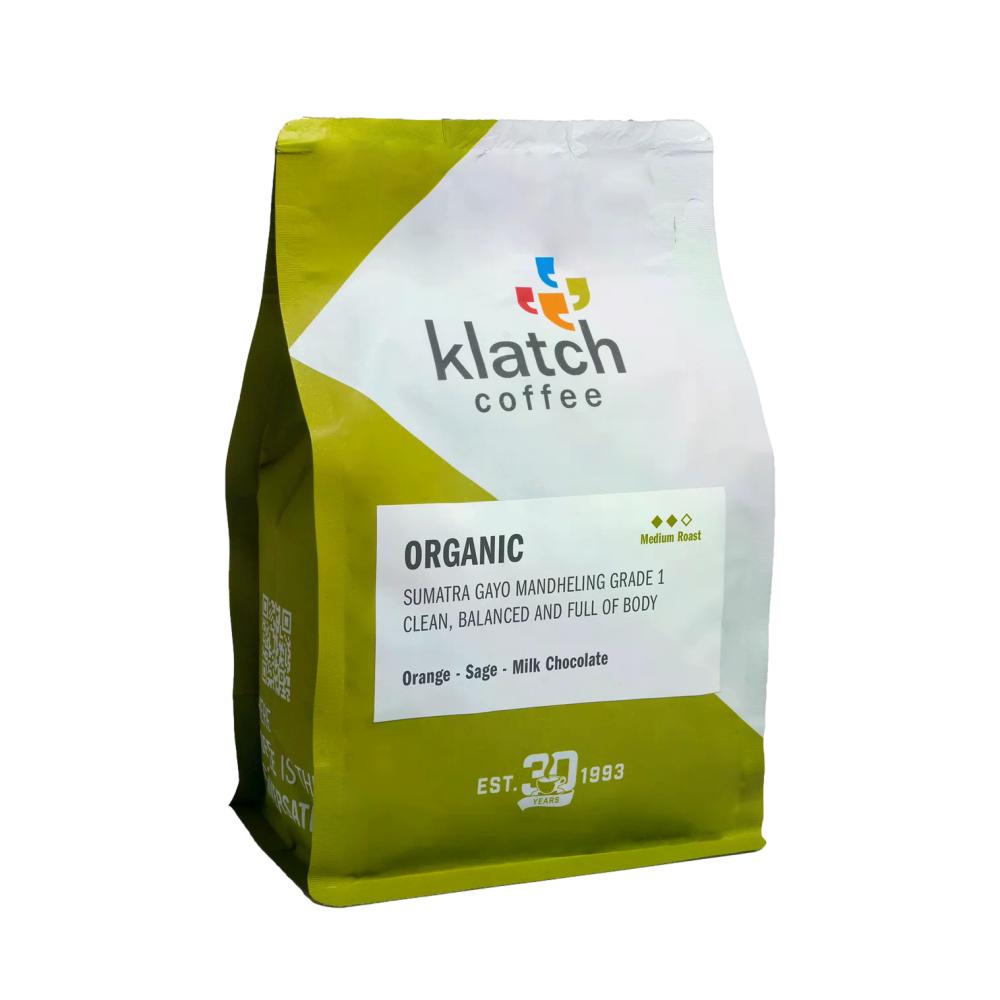 A bag of Klatch Coffee Organic Sumatra Gavo Mandheling Grade 1 coffee, featuring a lime green and white packaging design with a white label in the center.