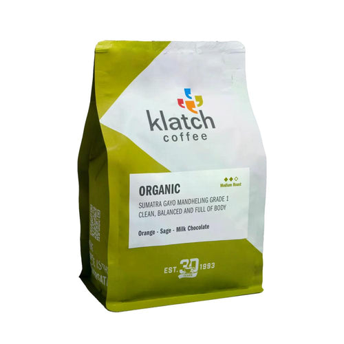 A bag of Klatch Coffee Organic Sumatra Gavo Mandheling Grade 1 coffee, featuring a lime green and white packaging design with a white label in the center.