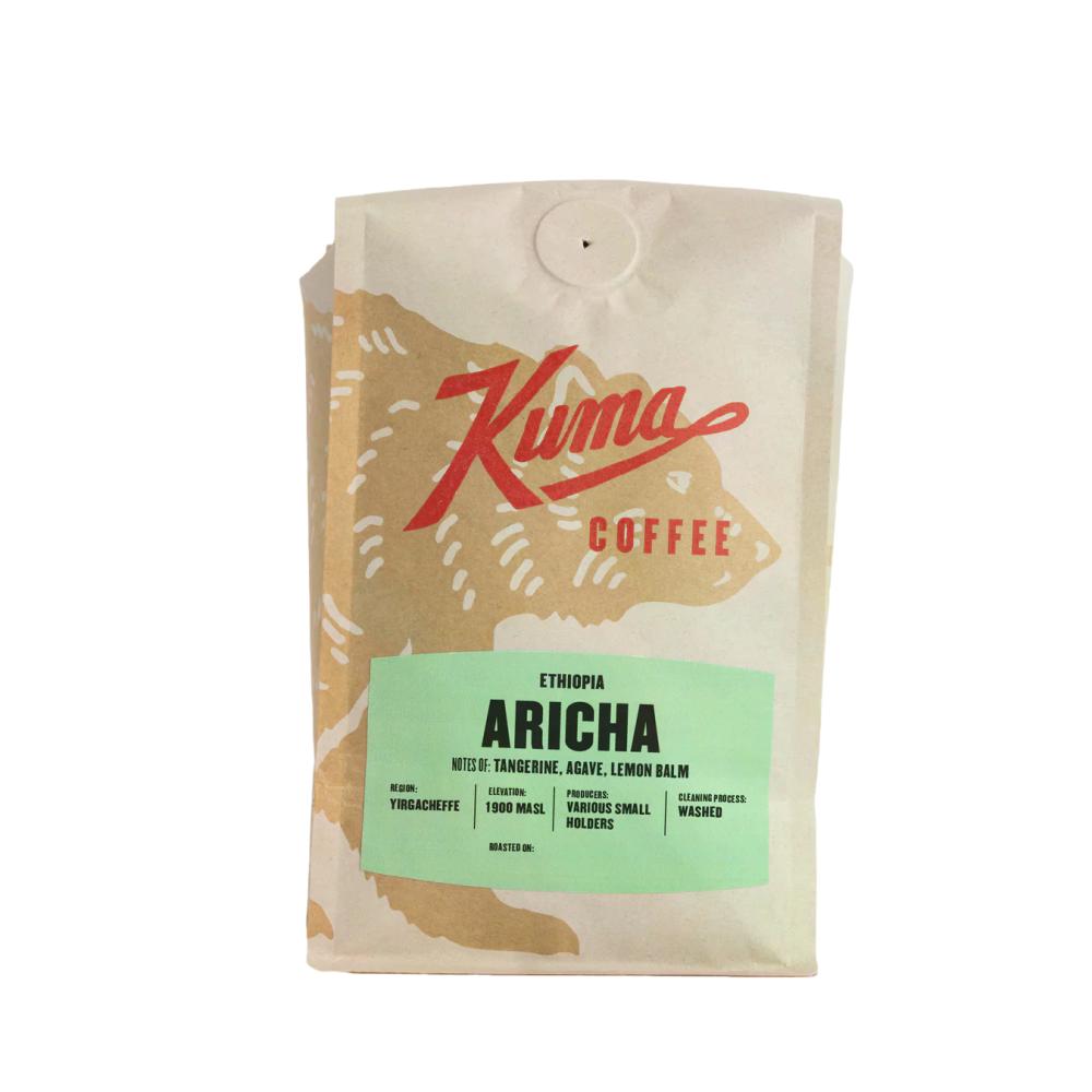 A bag of Kuma Coffee Ethiopia Aricha medium roast whole bean coffee, featuring a kraft paper bag with a red logo and a light green label.