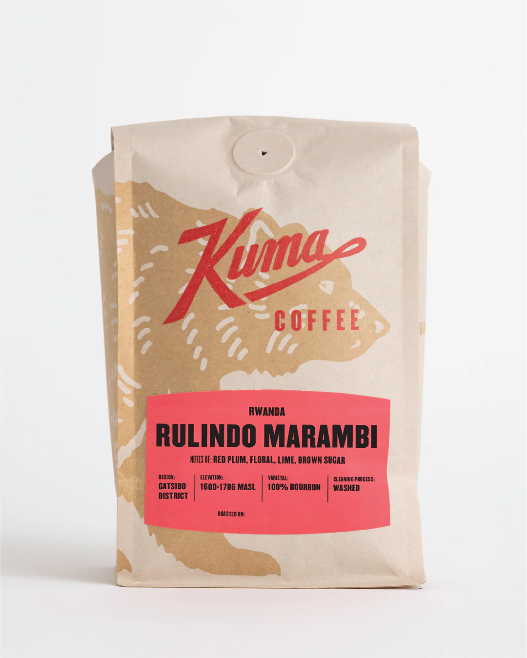 A stand-up coffee bag from Kuma Coffee on a clean white background. The packaging is cream-colored with a large tan bear silhouette and a bright pink label reading 'Rwanda Rulindo Marambi'.