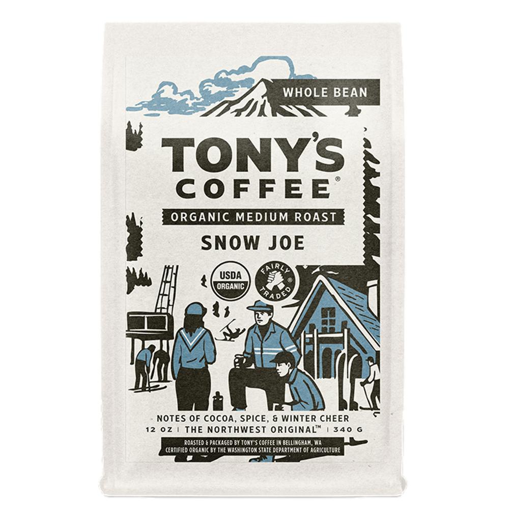 A bag of Tony's Coffee Organic Medium Roast Snow Joe whole bean coffee, featuring a cream-colored bag with a black and blue illustrated label depicting a winter mountain scene.