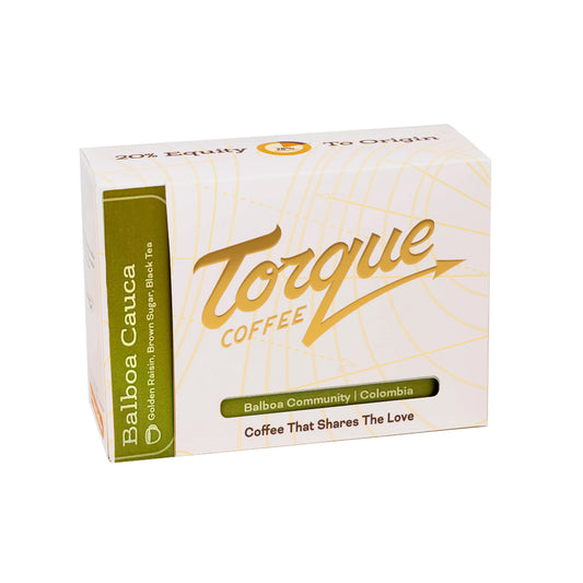 A box of Torque Coffee Balboa Cauca coffee, featuring a white box with gold script lettering and a green side panel, set against a plain white background.