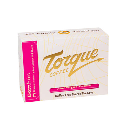 A box of Torque Coffee Bombón candy-coated lollipops, featuring a white box with gold script lettering and a bright pink side panel.