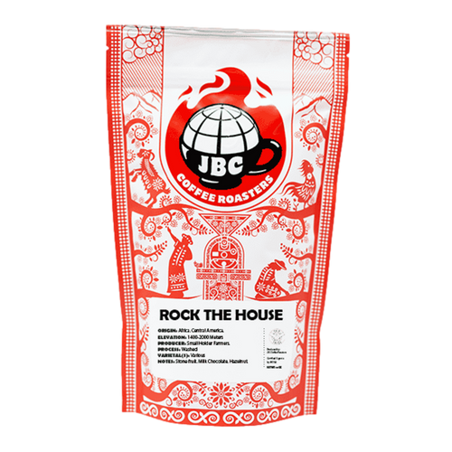 A bag of JBC Coffee Roasters 'Rock the House' blend coffee, with a red and white design featuring decorative patterns and the JBC logo.